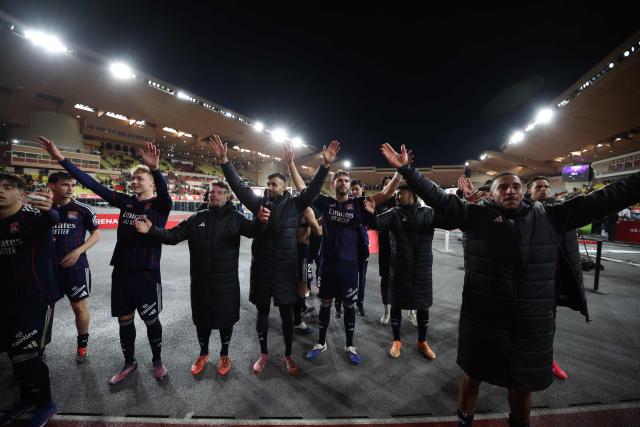 Lyon's players celebrate after winning the French L1 football match between AS Monaco and Olympique Lyonnais (OL) at the Stade Louis II in the Principality of Monaco on January 3, 2026. (Photo by Valery HACHE / AFP)