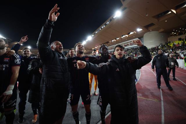 Lyon's players celebrate after winning the French L1 football match between AS Monaco and Olympique Lyonnais (OL) at the Stade Louis II in the Principality of Monaco on January 3, 2026. (Photo by Valery HACHE / AFP)