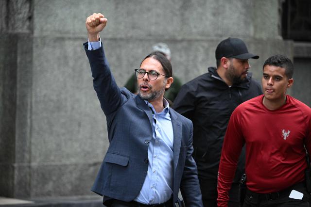 Venezuelan Minister of Communications Freddy Nanez, raises his clenched fist as he leaves the vice-presidency building in Caracas on January 3, 2026, after US forces captured Venezuela's President Nicolas Maduro. President Donald Trump said Saturday that US forces had captured Venezuela's leader Nicolas Maduro after bombing the capital Caracas and other cities in a dramatic climax to a months-long standoff between Trump and his Venezuelan arch-foe. (Photo by Federico PARRA / AFP)
