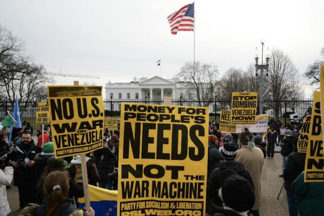 People take part in a demonstration against US military action in Venezuela in front of the White House in Washington, DC, on January 3, 2026. US President Donald Trump said Saturday that the United States will "run" Venezuela and tap its huge oil reserves after snatching leftist leader Nicolas Maduro out of the country during a bombing raid on Caracas. Trump's announcement came hours after a lightning attack in which special forces grabbed Maduro and his wife, while airstrikes pounded multiple sites, stunning the capital city. (Photo by Mandel NGAN / AFP)