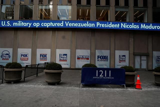 Fox News headlines display news about the US military's capture of Venezuelan President Nicolas Maduro, on the outside of the News Corp building in New York City on January 3, 2026. US President Donald Trump said Saturday that the United States will "run" Venezuela and tap its huge oil reserves after snatching leftist leader Nicolas Maduro out of the country during a bombing raid on Caracas. Trump's announcement came hours after a lightning attack in which special forces grabbed Maduro and his wife, while airstrikes pounded multiple sites, stunning the capital city. (Photo by John Lamparski / AFP)