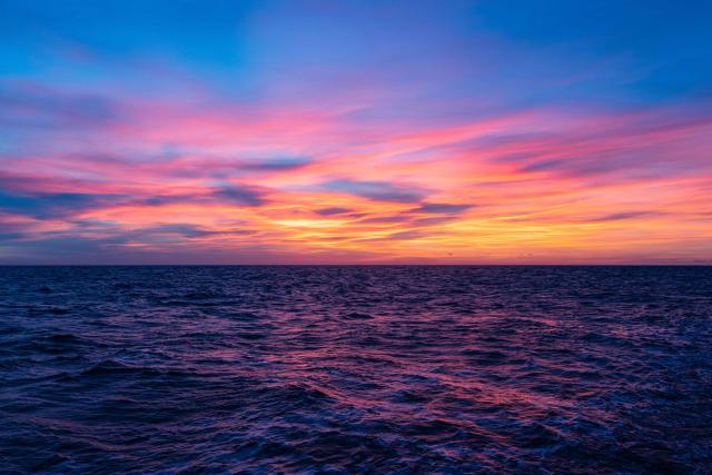 This photograph shows the sky during the sunrise over the Mediterranean Sea, off the Italian coasts on January 3, 2026. (Photo by Sameer Al-DOUMY / AFP)