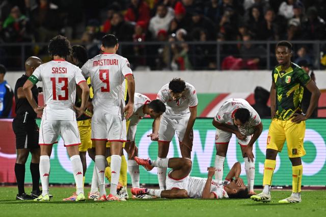 Mali's defender #26 Woyo Coulibaly (hidden) is expelled by South African referee Abongile Tom (L) after a fool on Tunisia's midfielder #10 Hannibal Mejbri (on the ground) during the Africa Cup of Nations (CAN) round of 16 football match between Mali and Tunisia at Mohammed V Stadium in Casablanca on January 3, 2026. (Photo by Paul ELLIS / AFP)