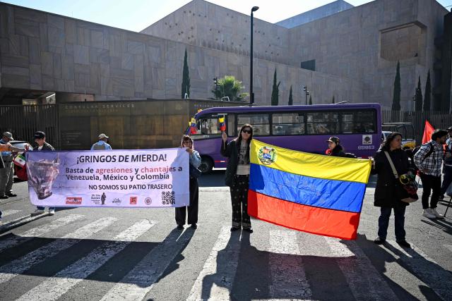 EDITORS NOTE: Graphic content / Members of social organizations protest with a sign reading "Shitty gringos. Stop agressions and blackmails to Venezuela, Mexico and Colombia. We are not your backyard," against the US military operation in Venezuela outside the US embassy in Mexico City on January 3, 2026, after US forces captured Venezuelan leader Nicolas Maduro. President Donald Trump said Saturday that US forces had captured Venezuela's leader Nicolas Maduro after bombing the capital Caracas and other cities in a dramatic climax to a months-long standoff between Trump and his Venezuelan arch-foe. (Photo by Alfredo ESTRELLA / AFP)