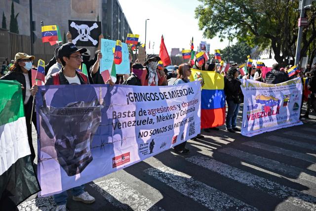 EDITORS NOTE: Graphic content / Members of social organizations protest with a sign reading "Shitty gringos. Stop agressions and blackmails to Venezuela, Mexico and Colombia. We are not your backyard," against the US military operation in Venezuela outside the US embassy in Mexico City on January 3, 2026, after US forces captured Venezuelan leader Nicolas Maduro. President Donald Trump said Saturday that US forces had captured Venezuela's leader Nicolas Maduro after bombing the capital Caracas and other cities in a dramatic climax to a months-long standoff between Trump and his Venezuelan arch-foe. (Photo by Alfredo ESTRELLA / AFP)