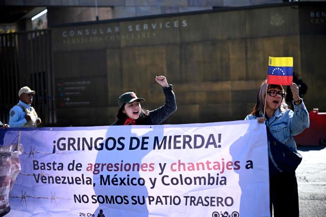 EDITORS NOTE: Graphic content / Members of social organizations protest with a sign reading "Shitty gringos. Stop agressions and blackmails to Venezuela, Mexico and Colombia. We are not your backyard," against the US military operation in Venezuela outside the US embassy in Mexico City on January 3, 2026, after US forces captured Venezuelan leader Nicolas Maduro. President Donald Trump said Saturday that US forces had captured Venezuela's leader Nicolas Maduro after bombing the capital Caracas and other cities in a dramatic climax to a months-long standoff between Trump and his Venezuelan arch-foe. (Photo by Alfredo ESTRELLA / AFP)