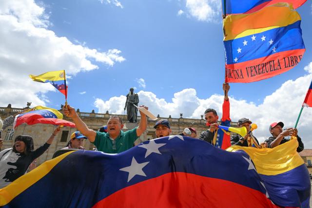 People celebrate at the Bolivar square in Bogota on January 3, 2026, after US forces captured Venezuelan leader Nicolas Maduro. President Donald Trump said Saturday that US forces had captured Venezuela's leader Nicolas Maduro after bombing the capital Caracas and other cities in a dramatic climax to a months-long standoff between Trump and his Venezuelan arch-foe. (Photo by Luis ACOSTA / AFP)