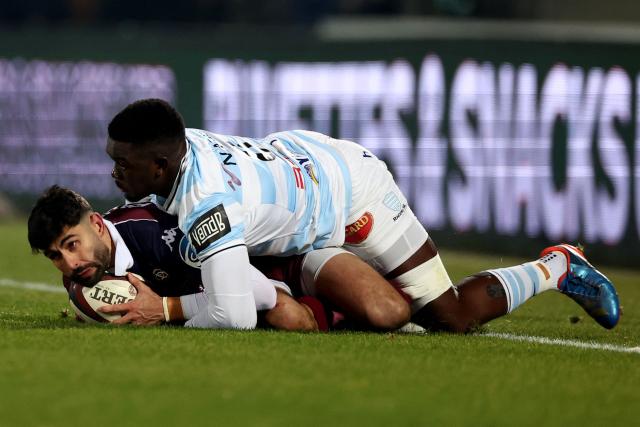 Bordeaux-Begles' French full-back Romain Buros (L) is tackled by Racing 92' Zimbabwean flanker Shingirai Manyarara during the French Top14 rugby union match between Union Bordeaux-Begles (UBB) and Racing 92 at the Chaban-Delmas Stadium in Bordeaux, south-western France on January 3, 2026. (Photo by ROMAIN PERROCHEAU / AFP)