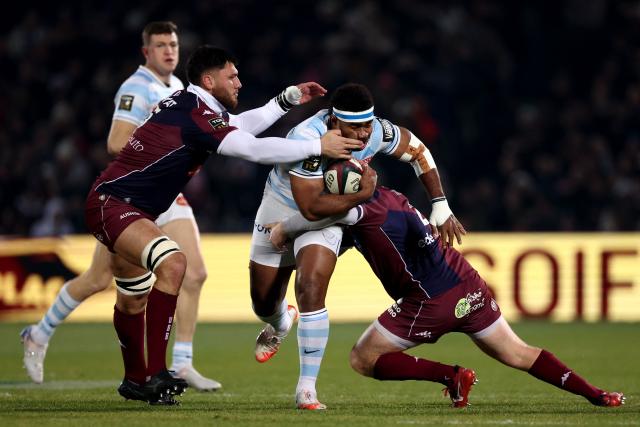 Racing 92' Fijian winger Vinaya Habosi (C) is tackled by Bordeaux-Begles' French lock Cyril Cazeaux (L) and Bordeaux-Begles' French hooker Maxime Lamothe (R) during the French Top14 rugby union match between Union Bordeaux-Begles (UBB) and Racing 92 at the Chaban-Delmas Stadium in Bordeaux, south-western France on January 3, 2026. (Photo by ROMAIN PERROCHEAU / AFP)