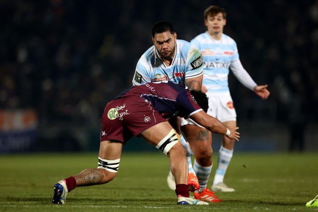 Racing 92' French lock Romain Taofifenua (C) is tackled by Bordeaux-Begles' French centre Yoram Moefana during the French Top14 rugby union match between Union Bordeaux-Begles (UBB) and Racing 92 at the Chaban-Delmas Stadium in Bordeaux, south-western France on January 3, 2026. (Photo by ROMAIN PERROCHEAU / AFP)