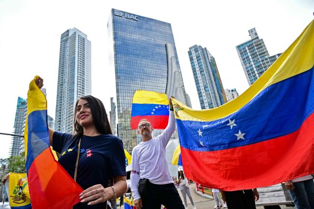 EDITORS NOTE: Graphic content / Venezuelans living in Panama celebrate with Venezuelan national flags in Panama City on January 3, 2026, after US forces captured Venezuelan leader Nicolas Maduro. President Donald Trump said Saturday that US forces had captured Venezuela's leader Nicolas Maduro after bombing the capital Caracas and other cities in a dramatic climax to a months-long standoff between Trump and his Venezuelan arch-foe. (Photo by MARTIN BERNETTI / AFP)