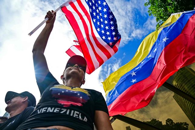 EDITORS NOTE: Graphic content / Venezuelans living in Panama celebrate with Venezuelan and US flags in Panama City on January 3, 2026, after US forces captured Venezuelan leader Nicolas Maduro. President Donald Trump said Saturday that US forces had captured Venezuela's leader Nicolas Maduro after bombing the capital Caracas and other cities in a dramatic climax to a months-long standoff between Trump and his Venezuelan arch-foe. (Photo by MARTIN BERNETTI / AFP)
