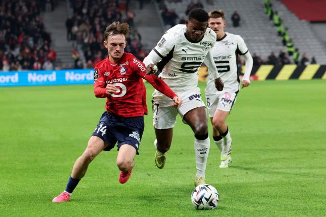 Lille's Norwegian forward #14 Marius Broholm (L) and Rennes' Swiss forward #07 Breel Embolo fight for the ball during the French L1 football match between Lille LOSC and Stade Rennais FC at the Stade Pierre-Mauroy in Villeneuve-d'Ascq, northern France, on January 3, 2026. (Photo by Francois LO PRESTI / AFP)