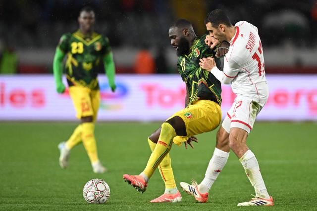 Mali's forward #17 Lassine Sinayoko fights for the ball with Tunisia's midfielder #17 Ellyes Skhiri during the Africa Cup of Nations (CAN) round of 16 football match between Mali and Tunisia at Mohammed V Stadium in Casablanca on January 3, 2026. (Photo by Paul ELLIS / AFP)