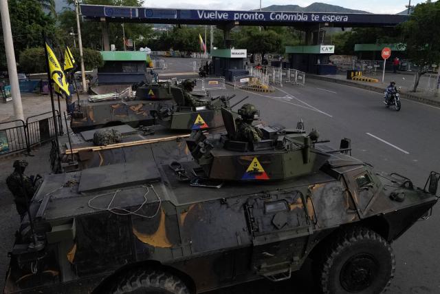TOPSHOT - This aerial view shows Colombian soldiers in military vehicles monitoring the border crossing with Venezuela in Cucuta, Colombia, on January 3, 2026, after US forces captured Venezuela's President Nicolas Maduro. President Donald Trump said on January 3, 2025, that US forces had captured Venezuela's leader Nicolas Maduro after bombing the capital Caracas and other cities in a dramatic climax to a months-long standoff between Trump and his Venezuelan arch-foe. (Photo by Raul ARBOLEDA / AFP)