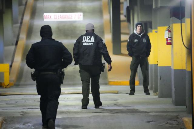 DEA agents wait at the US Drug Enforcement Administration (DEA) headquarters in lower Manhattan as Venezuelan President Nicolas Maduro is expected to be transferred on January 3, 2026. Venezuelan President Nicolas Maduro arrived on the evening of January 3 at a military base in the United States after his capture by US forces in Caracas. Maduro was seen surrounded by FBI agents as he descended the boarding stairs of a US government plane at a New York state National Guard facility, and was slowly escorted along the tarmac. (Photo by Bryan R. SMITH / AFP)