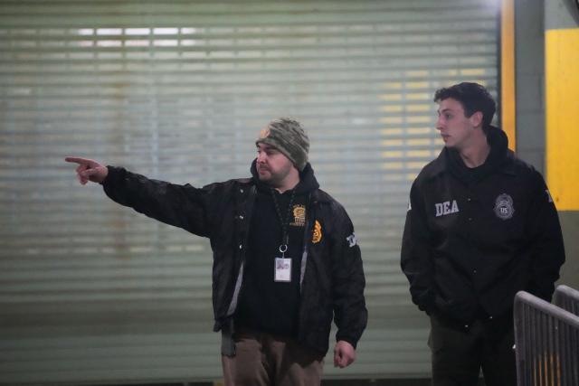 DEA agents wait at the US Drug Enforcement Administration (DEA) headquarters in lower Manhattan as Venezuelan President Nicolas Maduro is expected to be transferred on January 3, 2026. Venezuelan President Nicolas Maduro arrived on the evening of January 3 at a military base in the United States after his capture by US forces in Caracas. Maduro was seen surrounded by FBI agents as he descended the boarding stairs of a US government plane at a New York state National Guard facility, and was slowly escorted along the tarmac. (Photo by Bryan R. SMITH / AFP)