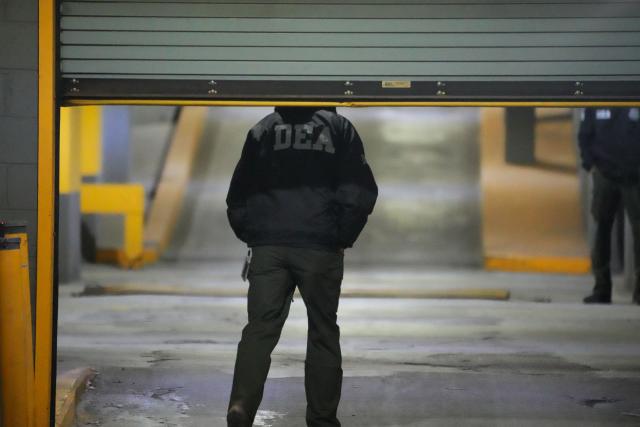 DEA agents wait at the US Drug Enforcement Administration (DEA) headquarters in lower Manhattan as Venezuelan President Nicolas Maduro is expected to be transferred on January 3, 2026. Venezuelan President Nicolas Maduro arrived on the evening of January 3 at a military base in the United States after his capture by US forces in Caracas. Maduro was seen surrounded by FBI agents as he descended the boarding stairs of a US government plane at a New York state National Guard facility, and was slowly escorted along the tarmac. (Photo by Bryan R. SMITH / AFP)