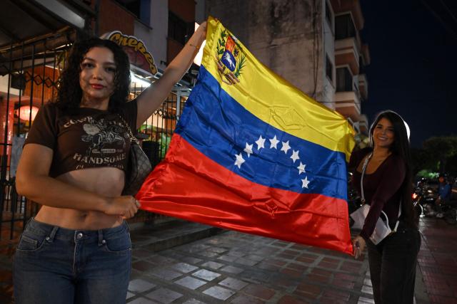 Venezuelans living in Colombia celebrate in Cucuta, Colombia, on January 3, 2026, after US forces captured Venezuelan leader Nicolas Maduro. President Donald Trump said on January 3, 2026, that US forces had captured Venezuela's leader Nicolas Maduro after bombing the capital Caracas and other cities in a dramatic climax to a months-long standoff between Trump and his Venezuelan arch-foe. (Photo by Raul ARBOLEDA / AFP)
