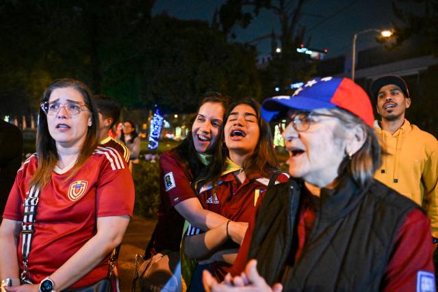 Venezuelans living in Guatemala sing their national anthem as they celebrate at Simon Bolivar Square in Guatemala City on January 3, 2026, after US forces captured Venezuelan leader Nicolas Maduro. President Donald Trump said on January 3, 2026, that US forces had captured Venezuela's leader Nicolas Maduro after bombing the capital Caracas and other cities in a dramatic climax to a months-long standoff between Trump and his Venezuelan arch-foe. (Photo by JOHAN ORDONEZ / AFP)