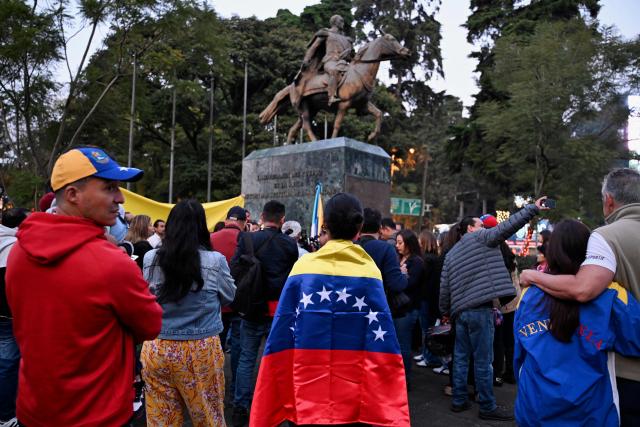 Venezuelans living in Guatemala celebrate at Simon Bolivar Square in Guatemala City on January 3, 2026, after US forces captured Venezuelan leader Nicolas Maduro. President Donald Trump said on January 3, 2026, that US forces had captured Venezuela's leader Nicolas Maduro after bombing the capital Caracas and other cities in a dramatic climax to a months-long standoff between Trump and his Venezuelan arch-foe. (Photo by JOHAN ORDONEZ / AFP)