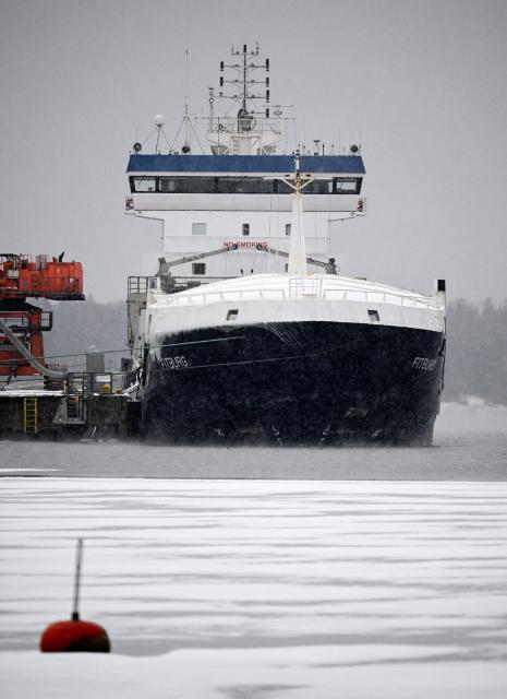 The Fitburg vessel which was seized by authorities sits in the port of Kantvik, Kirkkonummi on January 4, 2026, following damage to a telecommunications cable between Helsinki and the Estonian capital Tallinn. Finnish police said January 3, that they were questioning four crew members aboard a ship suspected of damaging a telecommunications cable between Helsinki and the Estonian capital Tallinn. On December 31, 2025, police detained the Fitburg, a 132-metre-long (433-foot-long) cargo ship en route from St Petersburg, Russia, to Haifa, Israel, following suspicion that the ship's anchor had damaged the subsea cable in the Gulf of Finland. (Photo by Markku Ulander / Lehtikuva / AFP) / Finland OUT