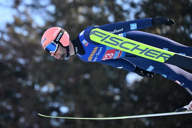 Germany's Pius Paschke soars through the air during the trial round for the Men's Individual Large Hill HS128 event of the FIS Ski Jumping World Cup, the third leg of the Four Hills Tournament, in Innsbruck, Austria on January 4 , 2026. (Photo by KERSTIN JOENSSON / AFP)