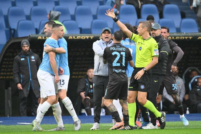 Lazio’s Montenegrin defender #77 Adam Marusic (L) receives a red card from Italian referee Davide Massa during the Italian  Serie A football match between Lazio and Napoli at The Olympic Stadium in Rome on January 4, 2026. (Photo by Alberto PIZZOLI / AFP)