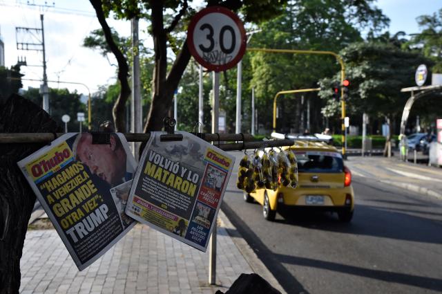 View of front pages reading "Make Venezuela great again" and depicting US President Donald Trump next to another one reading "He came back and he was killed," at a newspaper stall in Cucuta, Colobia, on the border with Venezuela, a day after a US strike ousted Venezuela's president Nicolas Maduro. The government of Colombia announced Saturday that it is preparing to declare an “economic state of emergency” on the border with Venezuela following the United States’ attacks in that country and the capture of its president, Nicolas Maduro, in the early hours of the morning. (Photo by Schneyder Mendoza / AFP)