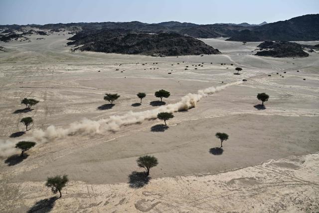 TOPSHOT - Dacia Sandriders' Qatari driver Nasser al-Attiyah and Belgian co-driver Fabian Lurquin compete in the Stage 1 of the 48th edition of the Dakar Rally 2026, between Yanbu and Yanbu, Saudi Arabia, on January 4, 2026. (Photo by Giuseppe CACACE / AFP)