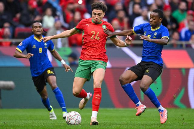 Morocco's midfielder #24 Neil El Aynaoui controls the ball in front of Tanzania's midfielder #06 Feisal Salum during the Africa Cup of Nations (CAN) round of 16 football match between Morocco and Tanzania at Prince Moulay Abdallah Stadium in Rabat on January 4, 2026. (Photo by SEBASTIEN BOZON / AFP)