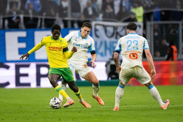 Nantes' French forward #11 Herba Guirassy (L) fights for the ball with Marseille's French defender #28 Benjamin Pavard during the French L1 football match between Olympique de Marseille (OM) and FC Nantes at the Stade Velodrome in Marseille, southern France on January 4, 2026. (Photo by MIGUEL MEDINA / AFP)