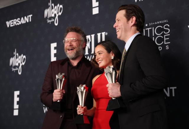 (L-R) Canadian-US actor Seth Rogen, US actress Chase Sui Wonders and US actor Ike Barinholtz, winners of the Best Comedy Series Award for "The Studio", pose in the press room during the 31st Annual Critics Choice Awards at Barker Hangar in Santa Monica, California, on January 4, 2026. (Photo by Michael Tran / AFP)
