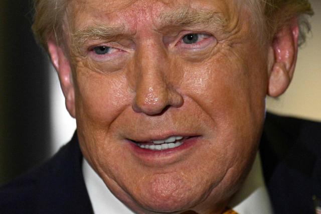 US President Donald Trump speaks with reporters aboard Air Force One on his way back to Washington, DC, on January 4, 2026. President Trump is returning to DC after spending the holidays at his Mar-a-Lago residence in Palm Beach, Florida. (Photo by Jim WATSON / AFP)