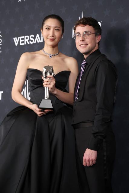 US singer EJAE and US composer Mark Sonnenblick pose in the press room with the Best Song award for "KPop Demon Hunters" during the 31st Annual Critics Choice Awards at Barker Hangar in Santa Monica, California, on January 4, 2026. (Photo by Michael Tran / AFP)