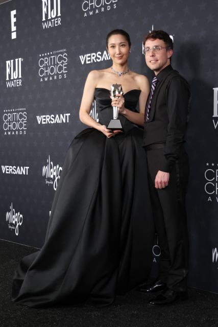 US singer EJAE and US composer Mark Sonnenblick pose in the press room with the Best Song award for "KPop Demon Hunters" during the 31st Annual Critics Choice Awards at Barker Hangar in Santa Monica, California, on January 4, 2026. (Photo by Michael Tran / AFP)