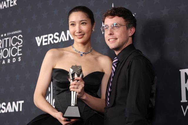 US singer EJAE and US composer Mark Sonnenblick pose in the press room with the Best Song award for "KPop Demon Hunters" during the 31st Annual Critics Choice Awards at Barker Hangar in Santa Monica, California, on January 4, 2026. (Photo by Michael Tran / AFP)