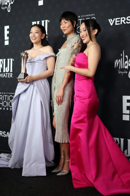 (L-R) Arden Cho, May Hong and Ji-young Yoo, winners of the Best Animated Feature Award for "KPop Demon Hunters", pose in the press room during the 31st Annual Critics Choice Awards at Barker Hangar in Santa Monica, California, on January 4, 2026. (Photo by Michael Tran / AFP)