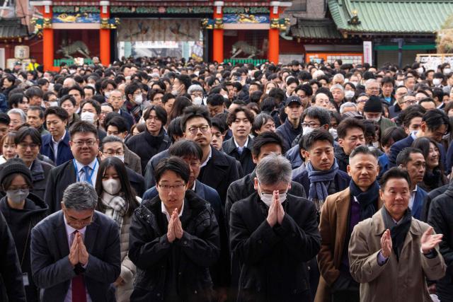 People visit Kanda Myojin Shrine to offer New Year prayers on the first business day of the year in Tokyo on January 5, 2026. (Photo by Kazuhiro NOGI / AFP)