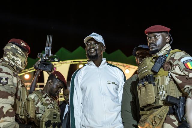 (FILES) Guinea President and presidential candidate Mamady Doumbouya (C) greets supporters during his final campaign rally ahead of the country's presidential election in Conakry on December 25, 2025. Junta chief Mamady Doumbouya won the Guinean presidential election with 86.72 percent of votes, according to official results published by the Supreme Court on January 4, 2026. (Photo by PATRICK MEINHARDT / AFP)