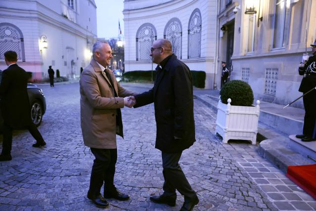 France's junior Minister in charge of parliament relations Laurent Panifous (L) is welcomed by France's Interior Minister Laurent Nunez as he arrives to take part in a breakfast with ministers at French Interior ministry Hotel de Beauvau in Paris on January 5, 2026. (Photo by Thomas SAMSON / POOL / AFP)