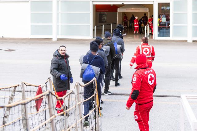 Migrants disembark from the rescue ship "Ocean Viking," operated by the NGO SOS Mediterranee, at the port of Savona, northwestern Italy, on January 5, 2026. 33 migrants were saved by crew members of the rescue ship "Ocean Viking" operated by the NGO SOS Mediterranee on December 31, 2025. They had been stranded on the oil tanker the "Maridive 703" for 5 days in the joint search zone between Malta and Tunisia in international Mediterranean waters. (Photo by Sameer Al-DOUMY / AFP)