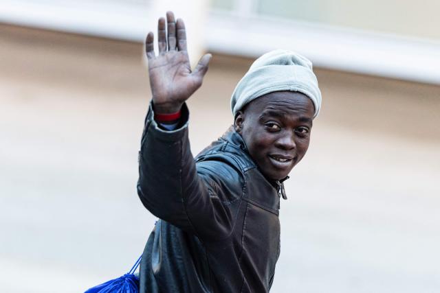 A migrant bids farewell to crew members of the rescue ship "Ocean Viking" operated by the NGO SOS Mediterranee, as he disembarks at the port of Savona, northwestern Italy, on January 5, 2026. 33 migrants were saved by crew members of the rescue ship "Ocean Viking" operated by the NGO SOS Mediterranee on December 31, 2025. They had been stranded on the oil tanker the "Maridive 703" for 5 days in the joint search zone between Malta and Tunisia in international Mediterranean waters. (Photo by Sameer Al-DOUMY / AFP)
