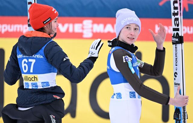 Winner Slovenia's Nika Prevc (R) and third placed Germany's Selina Freitag react after competingthe normal hill HS98 event of the women's FIS Ski Jumping World Cup in Villach, Austria on January 5, 2026. (Photo by BARBARA GINDL / APA / AFP) / Austria OUT