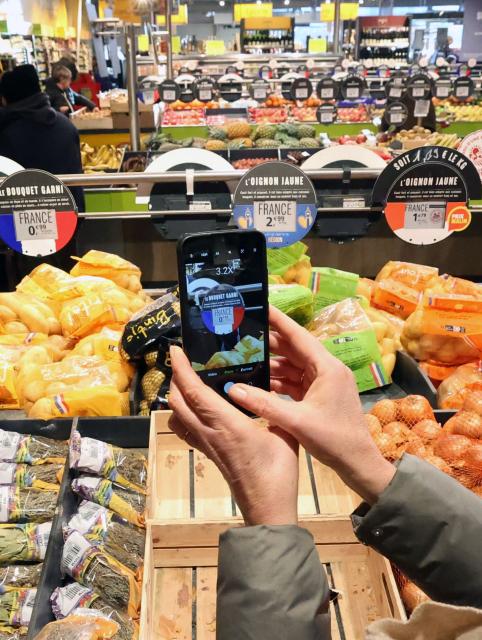 Inspectors from the departmental directorate for the protection of populations take pictures of food products to check their origin during a surprise visit at a "Grand Frais" food supermarket in Arras, on January 5, 2026. (Photo by Francois LO PRESTI / AFP)