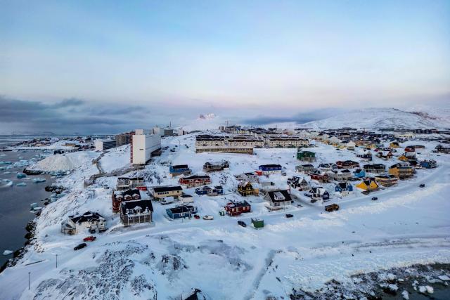 (FILES) This aerial view shows snow-covered buildings in Nuuk, Greenland, on March 7, 2025. Any US attack on a NATO ally would be the end of "everything", Denmark's Prime Minister Mette Frederiksen warned on January 5, 2026, after US President Donald Trump repeated his desire to annex Greenland. "If the United States decides to militarily attack another NATO country, then everything would stop -- that includes NATO and therefore post-World War II security," Frederiksen told Danish television network TV2. (Photo by Odd ANDERSEN / AFP)