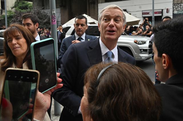 Chile's President-elect Jose Antonio Kast greets supporters after receiving the proclamation act at the Electoral Court in Santiago on January 5, 2026. (Photo by Rodrigo ARANGUA / AFP)