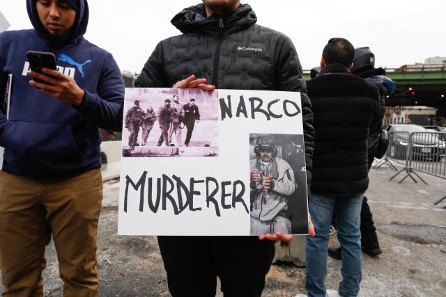 Demonstrators hold anti-Maduro signs outside the the Metropolitan Detention Center in the Brooklyn borough of New York City, where ousted Venezuelan president Nicolas Maduro is being held on January 5, 2026. Deposed Venezuelan president Nicolas Maduro pleaded not guilty to charges of narco-terrorism in a New York court on Monday, two days after being snatched by US forces in a stunning raid on his home in Caracas. Maduro, 63, told a federal judge in Manhattan that he had been "kidnapped" from Venezuela and said "I'm innocent, I'm not guilty," US media reported. (Photo by Kena Betancur / AFP)