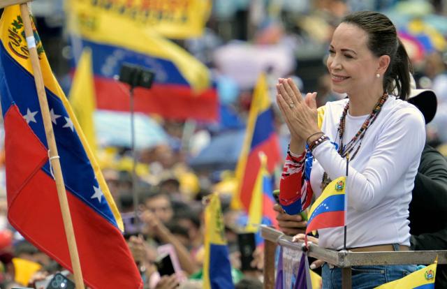 (FILES) Venezuelan opposition leader Maria Corina Machado gestures during a campaign rally of presidential candidate Edmundo Gonzalez, in Barinas, Venezuela, on July 6, 2024. On January 5, 2026, Venezuelan opposition leader Maria Corina Machado said she plans to return home "as soon as possible," and slammed the interim leader in Caracas. (Photo by Juan BARRETO / AFP)
