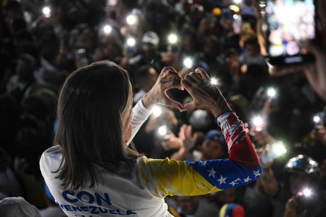 (FILES) Venezuelan opposition leader Maria Corina Machado gestures during the campaign closing rally of Venezuelan opposition presidential candidate Edmundo Gonzalez Urrutia in Caracas on July 25, 2024, ahead of Sunday's presidential election. On January 5, 2026, Venezuelan opposition leader Maria Corina Machado said she plans to return home "as soon as possible," and slammed the interim leader in Caracas. (Photo by Federico PARRA / AFP)
